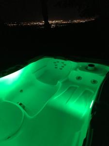 a green bath tub with a city in the background at Ivi in Svätý Jur