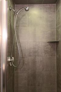 a shower with a glass door in a bathroom at Charlesmark Hotel in Boston