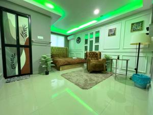 a living room with a couch and a table at RD Legend Hotel in Port Dickson