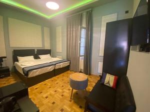 a small bedroom with a bed and a chair at La Casa Hotel Yerevan in Yerevan