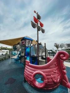 a playground with a slide in a park at Jervis Bay Holiday Park in Huskisson