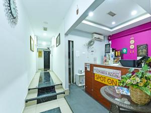 a lobby of a store with a pink wall at OYO 90138 Hotel Elwarda Klcity in Kuala Lumpur