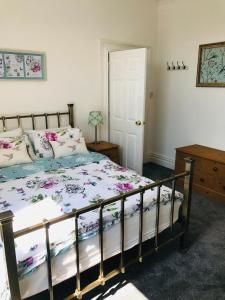 a bedroom with a bed and a table and a door at Character Town Centre 1 Bed Flat Boston in Boston