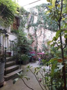 a brick wall with a painting of a butterfly on it at Le nichoir aux oiseaux avec Parking in Paris