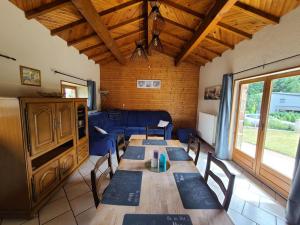 a living room with a table and a blue couch at Gîte Renauvoid, 4 pièces, 6 personnes - FR-1-589-417 in Chantraine