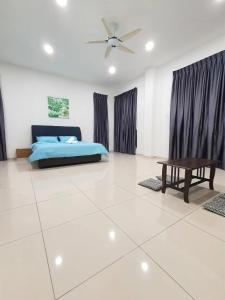a bedroom with a bed and a table in a room at Villa near Bukit Indah / Eco Botanic / Legoland / Horizon Hill in Gelang Patah