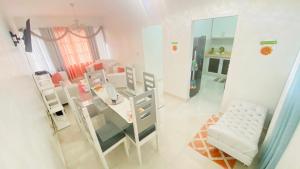 a living room with a glass table and chairs at 7 Santiago Minumental Area Lovely Specially 4 You - Cozy 3 bedrooms WIFI- Caribe tours - Colinas Mall and transportation 24 hours Apartment for 7 peoples in Marilópez