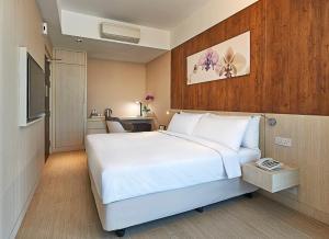 a hotel room with a bed and a desk at Oasia Suites Kuala Lumpur by Far East Hospitality in Kuala Lumpur