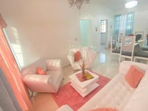 a living room with two couches and a table at 7 Santiago Minumental Area Lovely Specially 4 You - Cozy 3 bedrooms WIFI- Caribe tours - Colinas Mall and transportation 24 hours Apartment for 7 peoples in Marilópez
