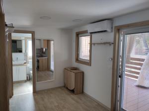a room with a bathroom with a sink and a mirror at Mobile homes King, Camp Dida in Pirovac