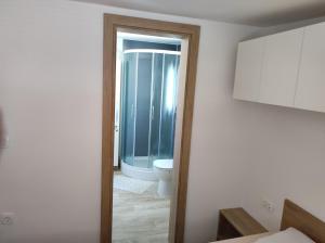a bathroom with a toilet and a glass shower at Mobile homes King, Camp Dida in Pirovac +27 photos