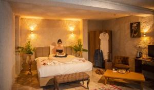 a bedroom with a doll sitting on a bed at Hydros Cave Suit in Uchisar