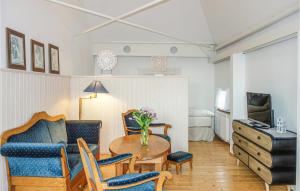 a living room with a table and chairs at 1 Bedroom Awesome Apartment In Detern in Detern