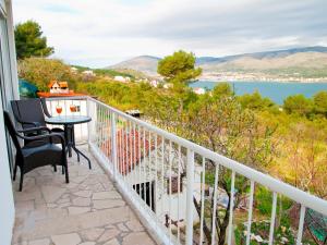a balcony with a table and chairs and a view of the water at Kadulja- Salvia in Trogir