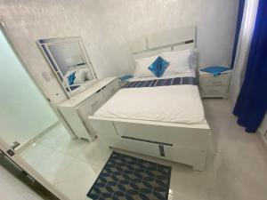a small bedroom with a bed and a mirror at 7 Santiago Minumental Area Lovely Specially 4 You - Cozy 3 bedrooms WIFI- Caribe tours - Colinas Mall and transportation 24 hours Apartment for 7 peoples in Marilópez +45 photos