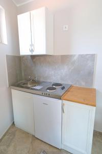 a kitchen with a stove and a sink at Fenix Apartments in Soko Banja