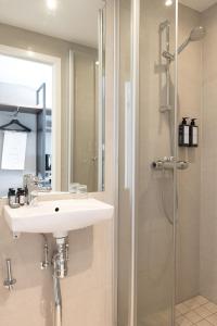 a bathroom with a sink and a shower at Elite Stadshotellet Växjö in Växjö +86 photos