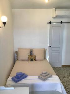 a bedroom with a bed with two towels on it at La Maisonette Antibes in Antibes
