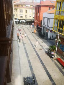 a view of a street with people walking down the street at ORTEGA SUITE, dúplex en el centro de Luanco in Luanco +6 photos