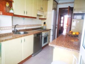 a kitchen with a sink and a dishwasher at ORTEGA SUITE, dúplex en el centro de Luanco in Luanco