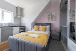 a bedroom with a large bed with two towels on it at Stunning 6 Bed House in Medway with 10 beds 4 bathrooms sleeps 15 in Gillingham