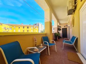 a balcony with chairs and a table and a window at Oasis apartment in Zadar