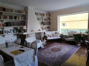 a living room with a table and chairs and a large window at B&B L'Uliveto in Montebuono