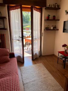 a living room with a door open to a patio at Il piccolo rifugio - Casa Valtournenche in Valtournenche