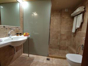 a bathroom with a sink and a shower and a toilet at Simosmare Resort in Elafonisos
