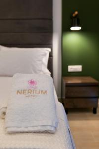 Postel nebo postele na pokoji v ubytování NERIUM Hotel