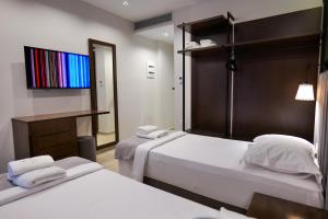 Postel nebo postele na pokoji v ubytování NERIUM Hotel