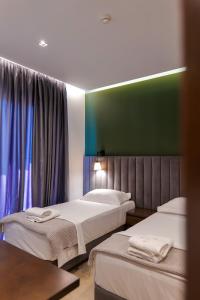 Postel nebo postele na pokoji v ubytování NERIUM Hotel
