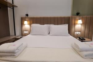Postel nebo postele na pokoji v ubytování NERIUM Hotel
