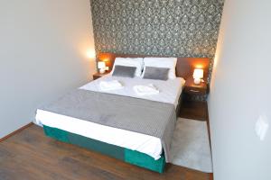 Postel nebo postele na pokoji v ubytování Fenix Apartments