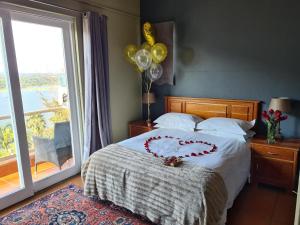 a bedroom with a bed with a heart on it at Letamong in Hartbeespoort