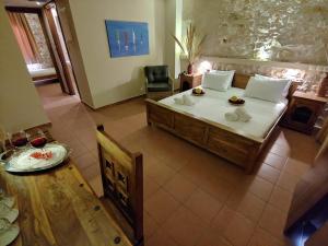 a bedroom with a large bed and a table and chair at Simosmare Resort in Elafonisos