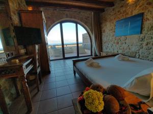 a bedroom with a bed and a view of the ocean at Simosmare Resort in Elafonisos