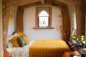 a bedroom with a bed and a window at The Queen Bee Cabin in Hereford