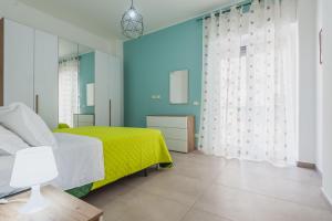 um quarto com uma cama verde e paredes azuis em Rapisardi 188 Apartment by Wonderful Italy em Catânia