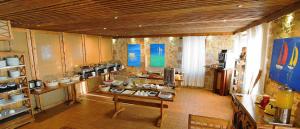 a large room with a kitchen with a table and counters at Simosmare Resort in Elafonisos