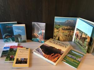 a bunch of books sitting on a table at Apartment Villa Huber in Bolzano