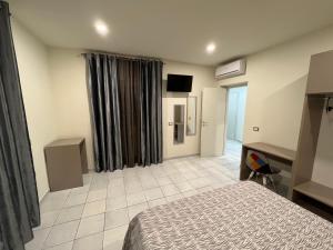 Posteľ alebo postele v izbe v ubytovaní Akoya Rooms Capo Vaticano