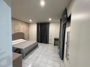 Posteľ alebo postele v izbe v ubytovaní Akoya Rooms Capo Vaticano