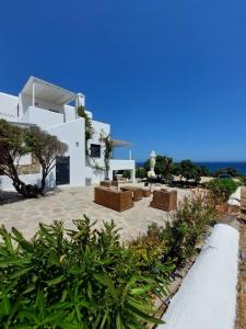 a white villa with a view of the ocean at Sophia & Chris Studios in Santa Maria