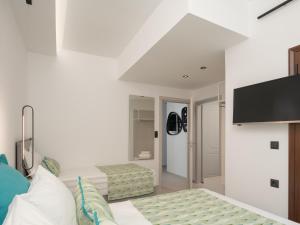 A television and/or entertainment centre at Anema Villa, a picture-perfect summer escape,By ThinkVilla
