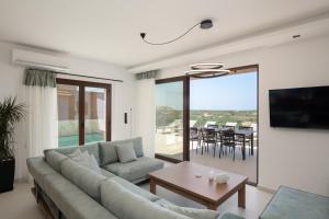 A television and/or entertainment centre at Anema Villa, a picture-perfect summer escape,By ThinkVilla