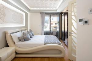 a bedroom with a bed in a room with a window at Ni President Suite, DeMaNi President Suites in Sitia