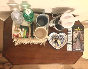 una mesa con tazas y otros artículos. en Piccolo girasole, en Perugia