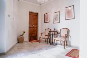 a dining room with two chairs and a table at Piccolo girasole in Perugia