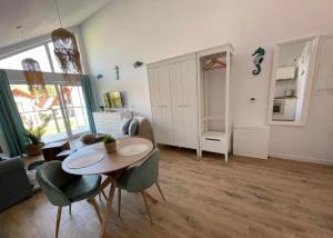 a living room with a table and chairs at Rajski Zakątek in Żarnowska +17 photos